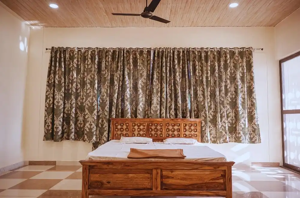 A cozy bed featuring a wooden headboard, complemented by a ceiling fan above, creating a comfortable atmosphere.